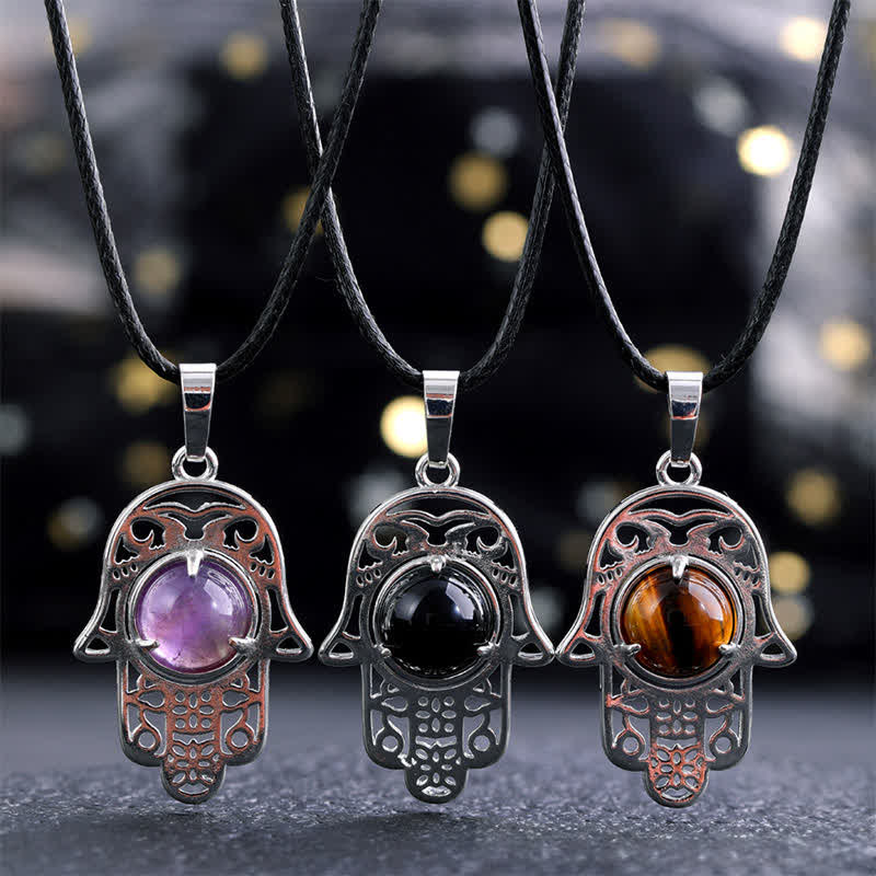 Buddha Stones Collana con intarsio in ossidiana nera naturale e palma Hamsa, simbolo di forza e resistenza. - image 0