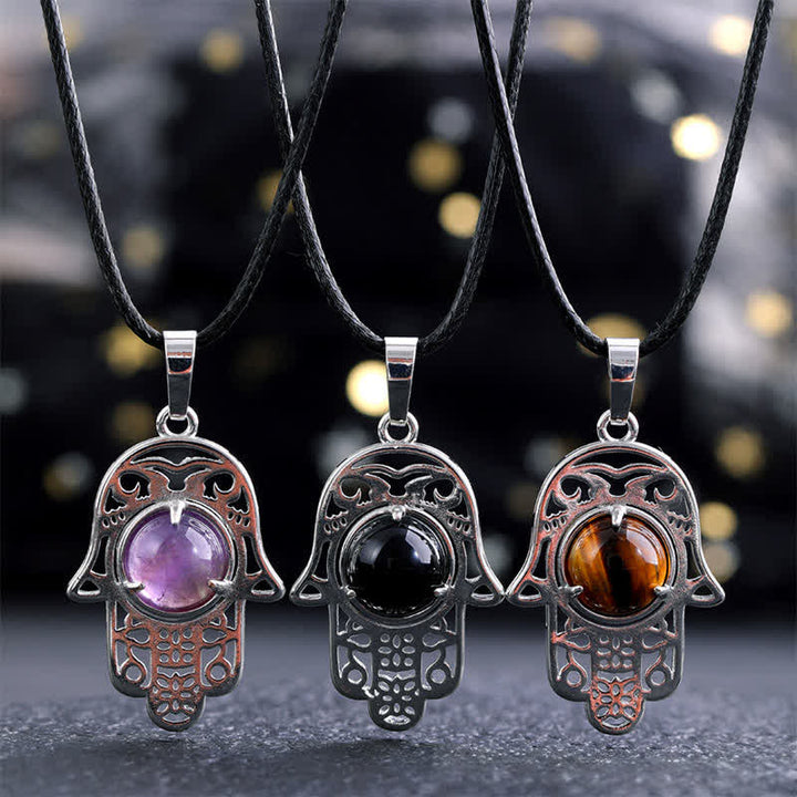Buddha Stones Collana con intarsio in ossidiana nera naturale e palma Hamsa, simbolo di forza e resistenza. - image 0