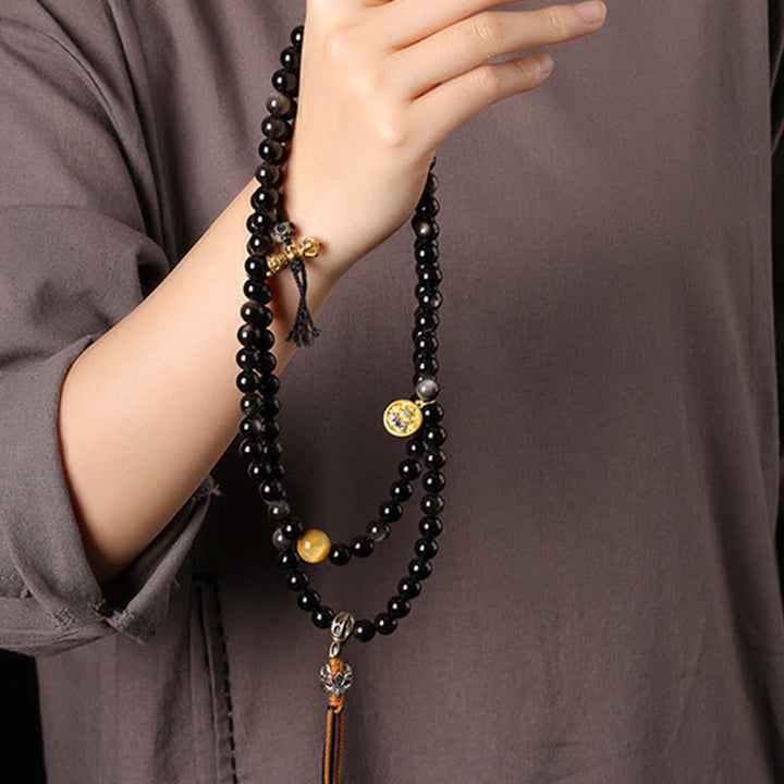 Buddha Stones Collana di perle intrecciate a mano con ciondolo a forma di Garuda in ossidiana con riflessi argentati, simbolo di protezione. - image 9
