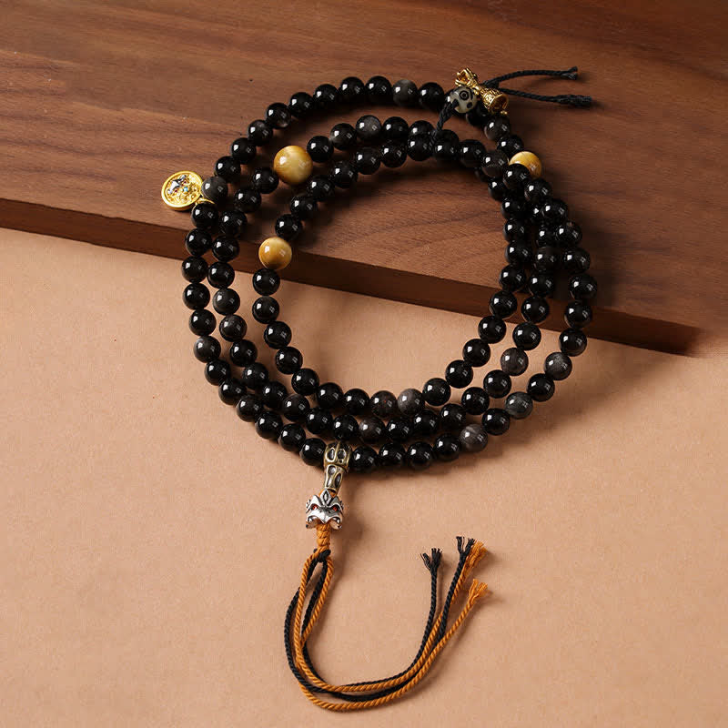 Buddha Stones Collana di perle intrecciate a mano con ciondolo a forma di Garuda in ossidiana con riflessi argentati, simbolo di protezione. - image 0