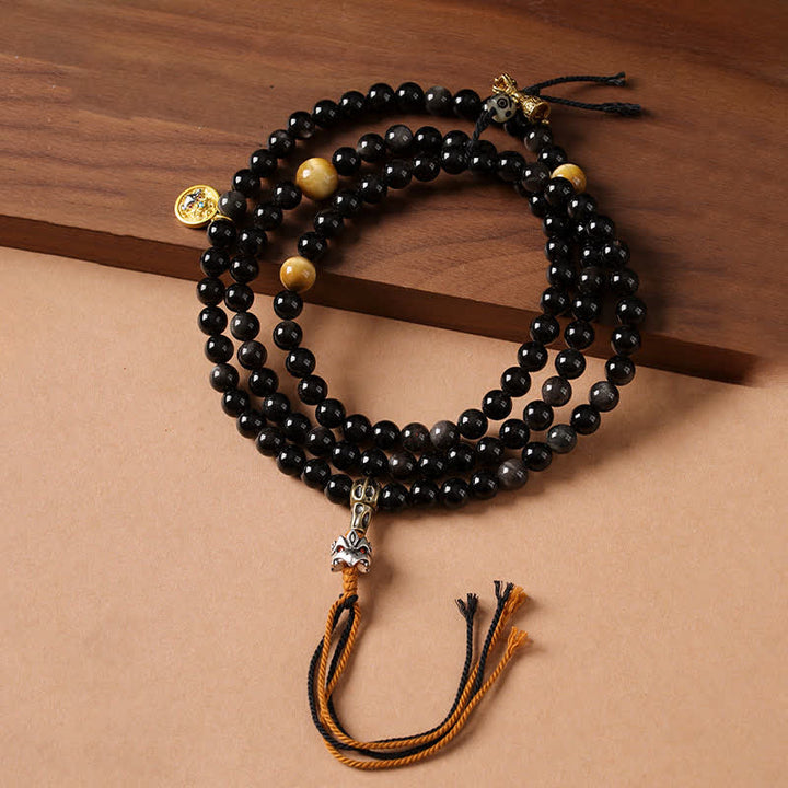 Buddha Stones Collana di perle intrecciate a mano con ciondolo a forma di Garuda in ossidiana con riflessi argentati, simbolo di protezione. - image 0