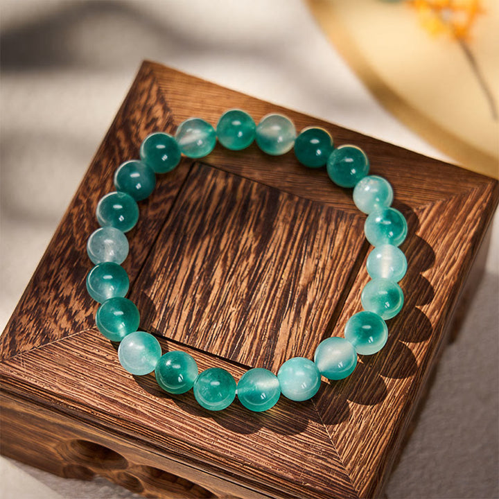 Buddha Stones Bracciale rotondo con perline blu e motivo floreale in calcedonio bianco e scritta "Equilibrio Emozionale" - image 1