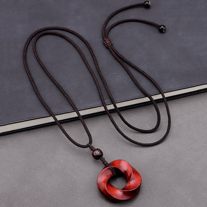 Buddha Stones Collana con ciondolo a forma di nodo infinito e corda dell'eternità in legno di sandalo rosso - image 1