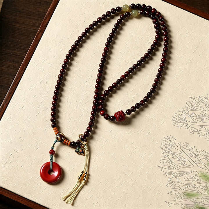 Buddha Stones Mala di protezione con fibbia della pace in legno di sandalo rosso, intrecciata a mano con 108 perline. - image 3