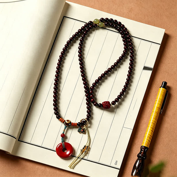 Buddha Stones Mala di protezione con fibbia della pace in legno di sandalo rosso, intrecciata a mano con 108 perline. - image 4