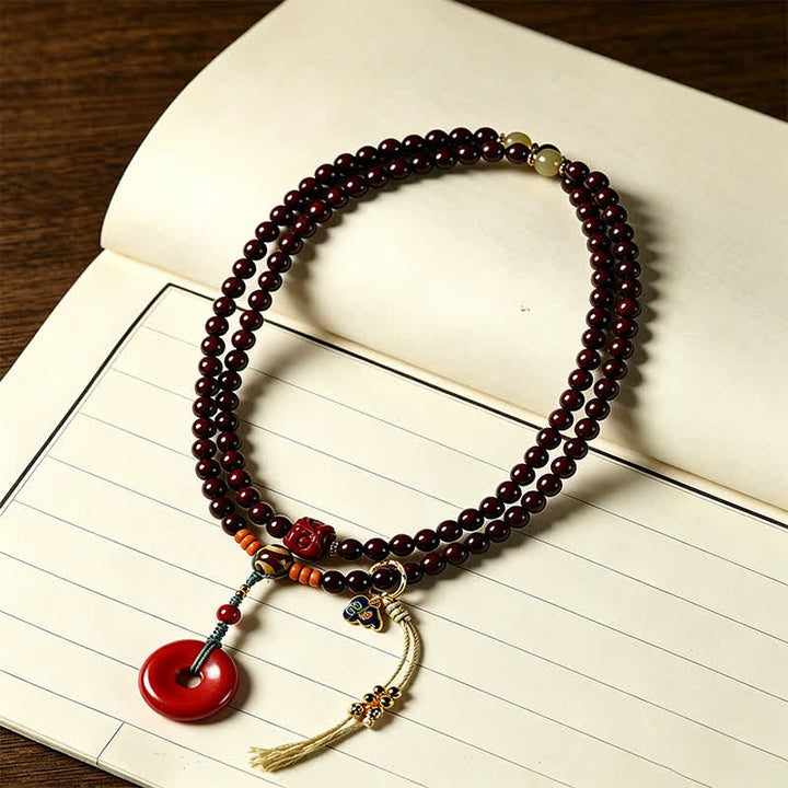 Buddha Stones Mala di protezione con fibbia della pace in legno di sandalo rosso, intrecciata a mano con 108 perline. - image 1