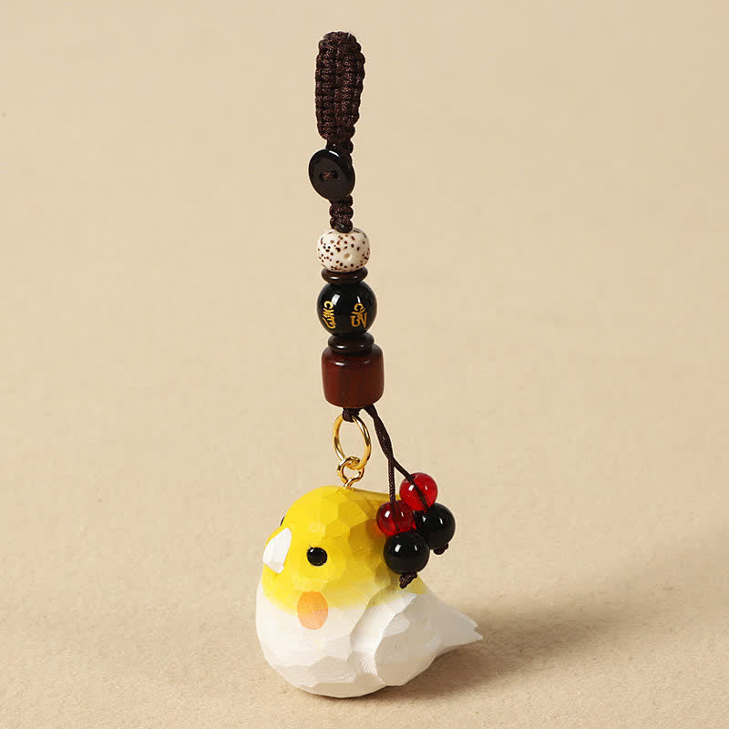 Buddha Stones Portachiavi in ​​legno naturale intagliato a mano con calopsite e simboli Om Mani Padme Hum Focus. - Cockatiel Om Mani Padme Hum - image 0
