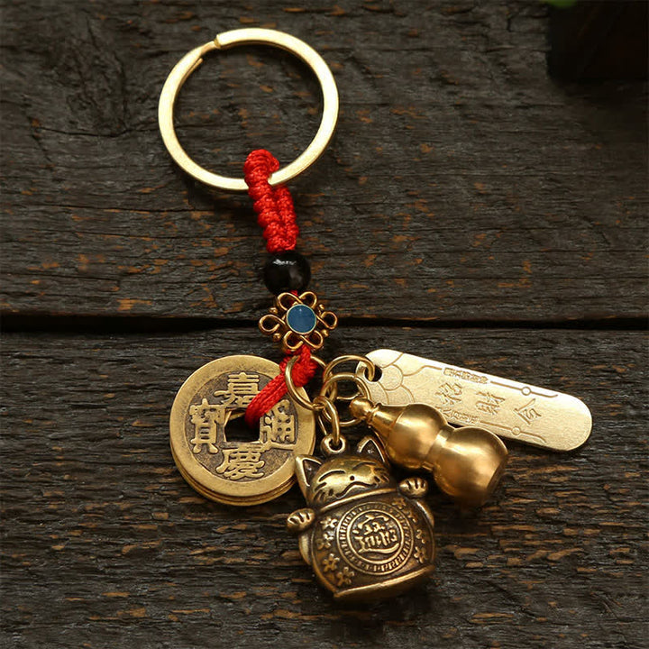 Buddha Stones Portachiavi in ​​ottone con moneta cinese portafortuna a forma di gatto. - Monete con cordino rosso - image 0