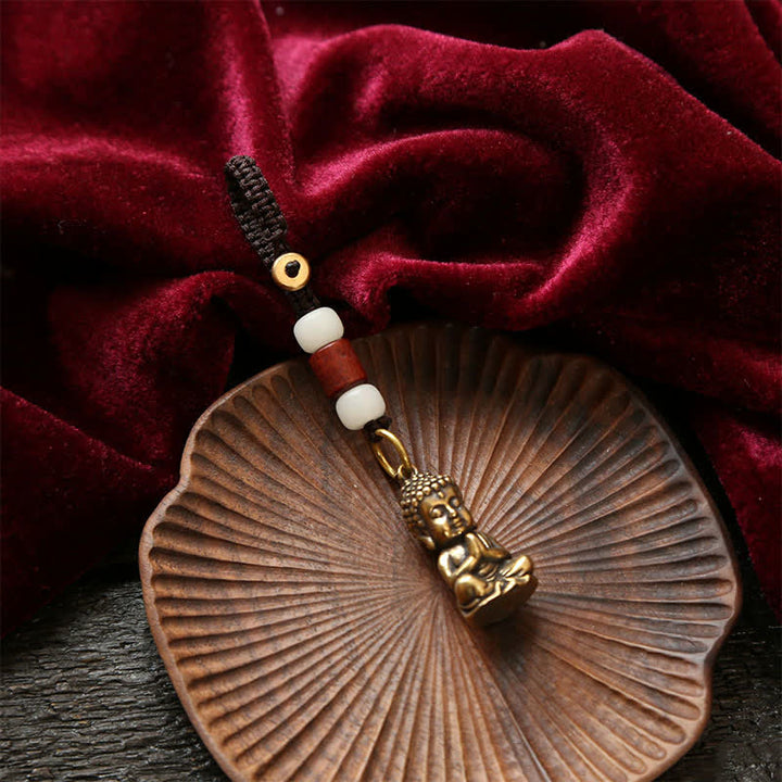 Buddha Stones Portachiavi in ​​ottone con Buddha e cinque monete dell'imperatore, cordino intrecciato, simbolo di compassione. - image 3