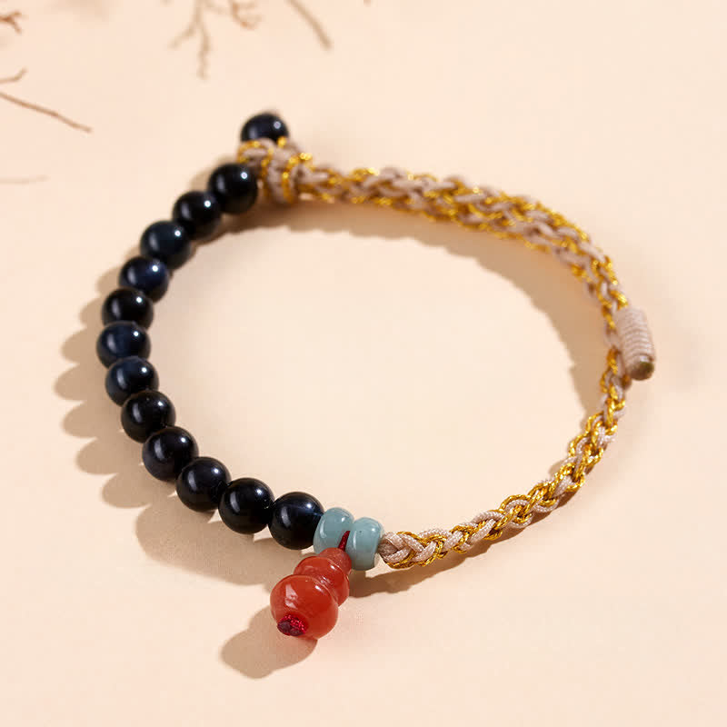 Buddha Stones Bracciale rinforzato con zucca intrecciata a mano e occhio di tigre blu. - image 1
