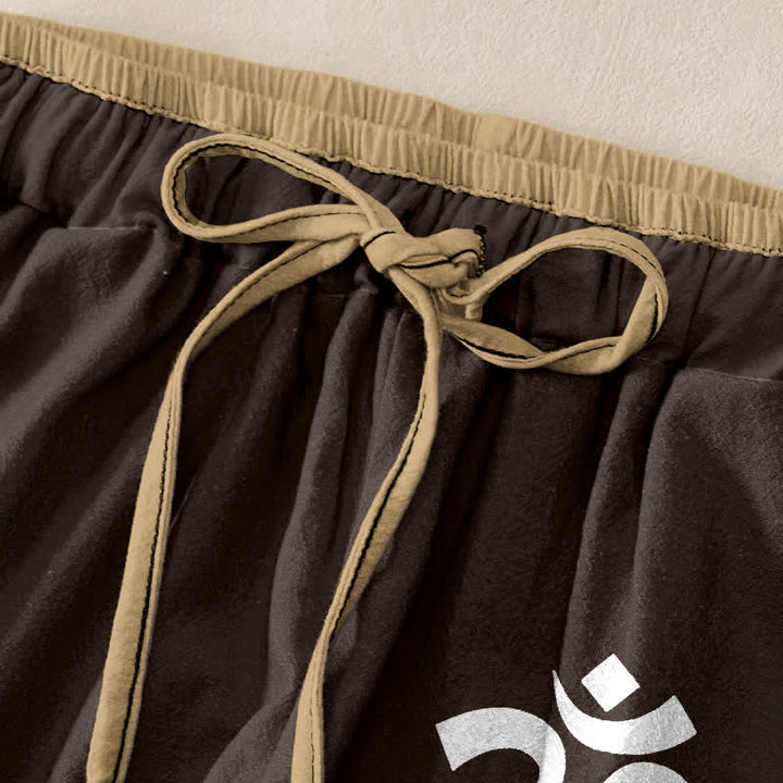 Buddha Stones Pantaloni da donna in puro cotone con elastico in vita e tasche, decorati con il simbolo Om. - image 1