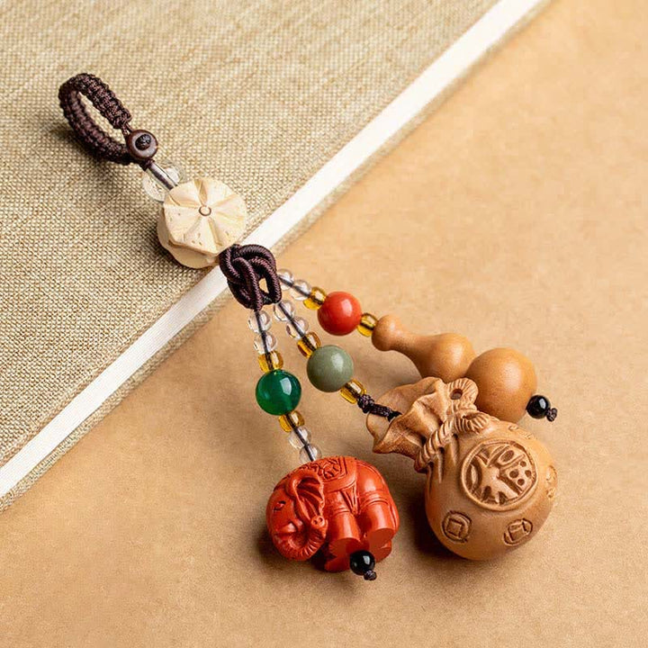 Buddha Stones Portafoglio con personaggio Fu in legno di pesca, portafortuna, elefante in cinabro, zucca di loto, portachiavi - Legno di pesco (Protezione ♥ Purificazione) - image 0