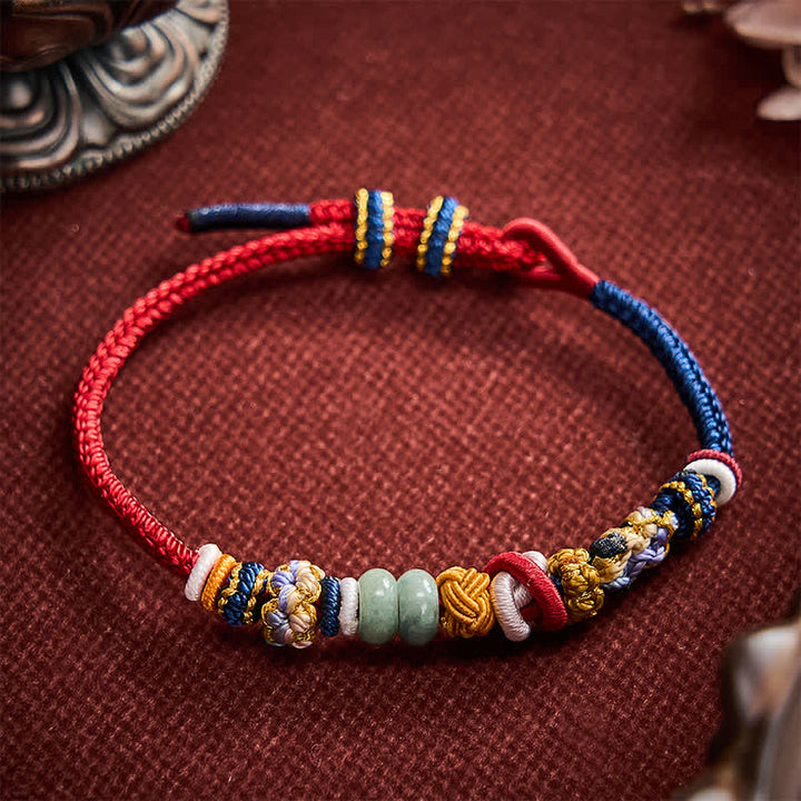 Buddha Stones Braccialetto con perline di giada a forma di fiore di pesco, intrecciate a mano, con cordino rosso e blu navy. - image 2