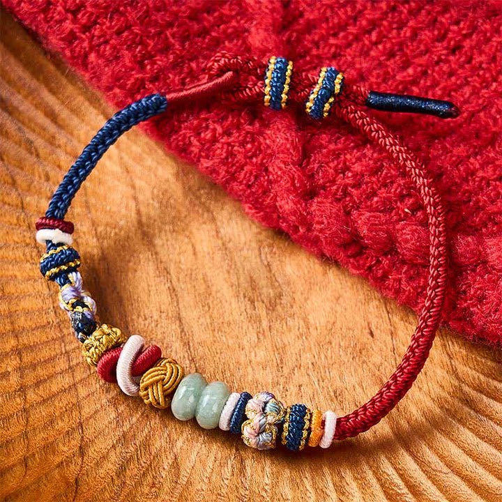 Buddha Stones Braccialetto con perline di giada a forma di fiore di pesco, intrecciate a mano, con cordino rosso e blu navy. - image 1