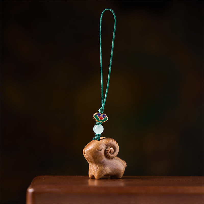 Buddha Stones Portachiavi in ​​legno di sandalo intagliati a mano con immagine positiva di una capra - image 1
