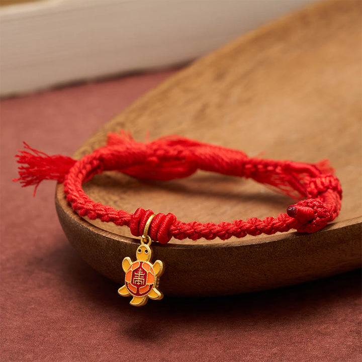 Buddha Stones Bracciale tibetano con ciondolo a forma di tartaruga, cordino rosso e filo placcato oro in rame. - image 1