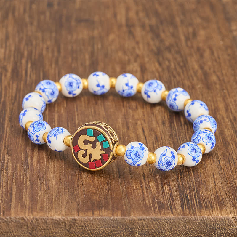 Buddha Stones Braccialetto con perline OM in rame, porcellana blu e bianca, simbolo di compassione. - image 1