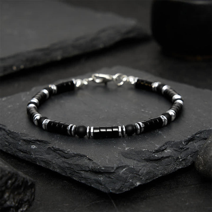Buddha Stones Bracciale protettivo con distanziatori cilindrici satinati in onice nera - image 1