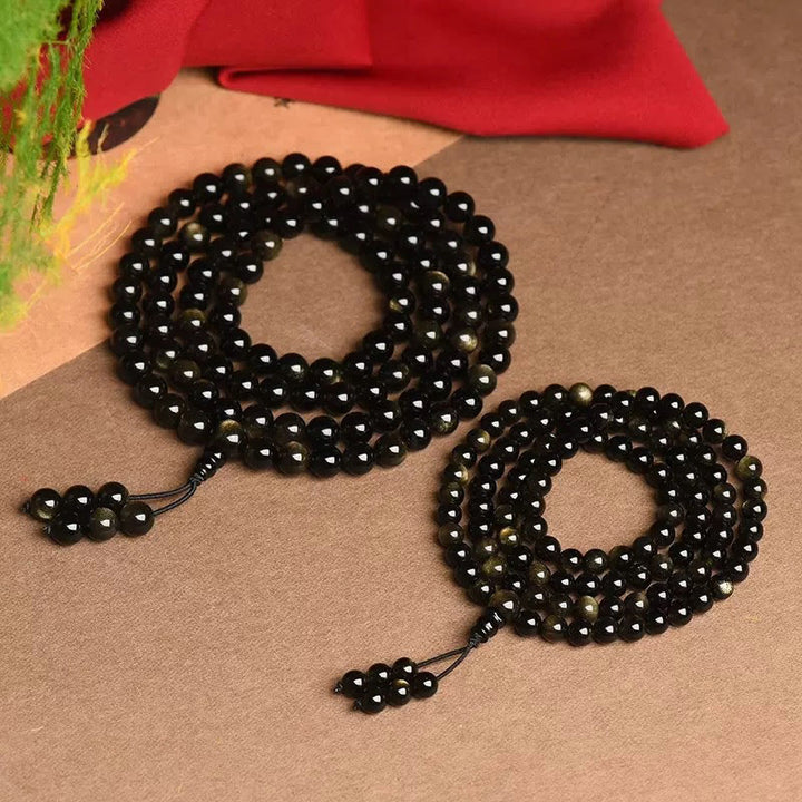 Braccialetto della ricchezza in ossidiana naturale con 108 perle di Mala Buddha Stones