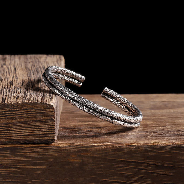 Bracciale rigido con polsino con motivo a drago inciso e bilanciamento