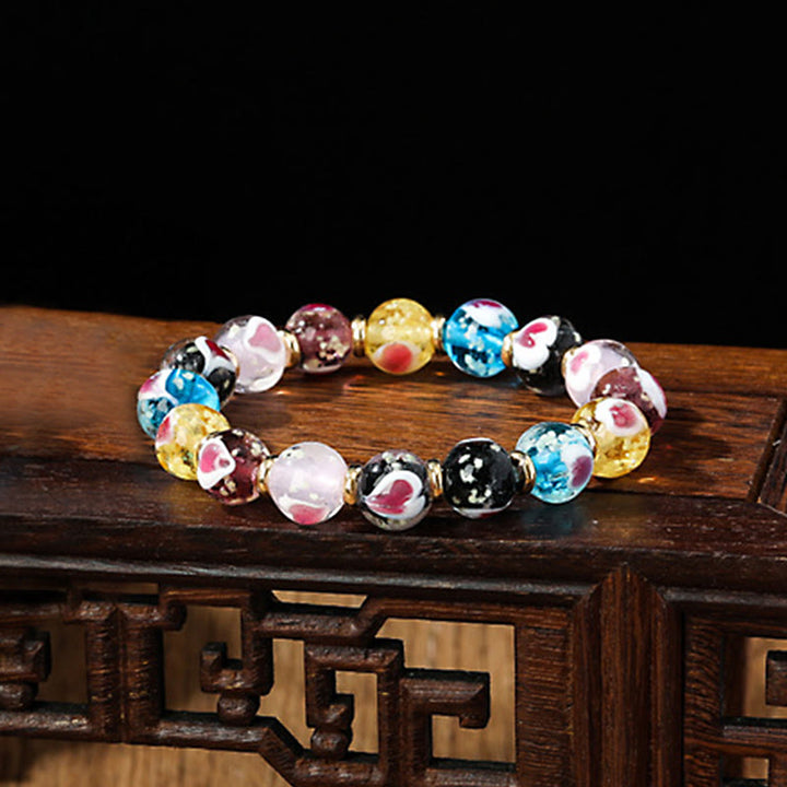 Braccialetto di perline di vetro fluorescente luminoso Liuli con cuore rosa della famiglia di bestie che ingoiano Buddha Stones