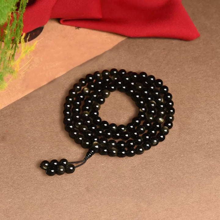 Braccialetto della ricchezza in ossidiana naturale con 108 perle di Mala Buddha Stones