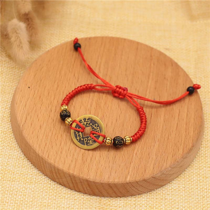 Braccialetto intrecciato con corda rossa, moneta di rame e Buddha Stones
