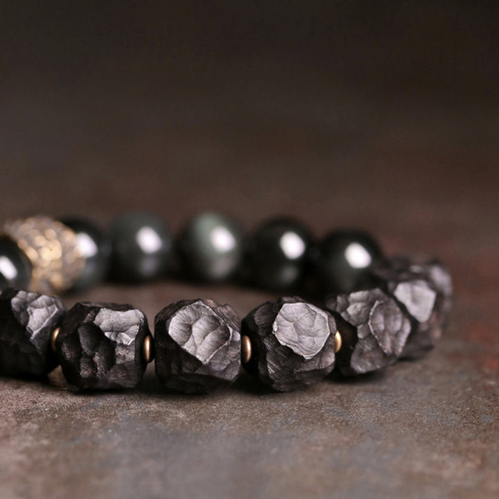 Braccialetto di coppia forza in rame, legno di ebano e ossidiana nera Buddha Stones