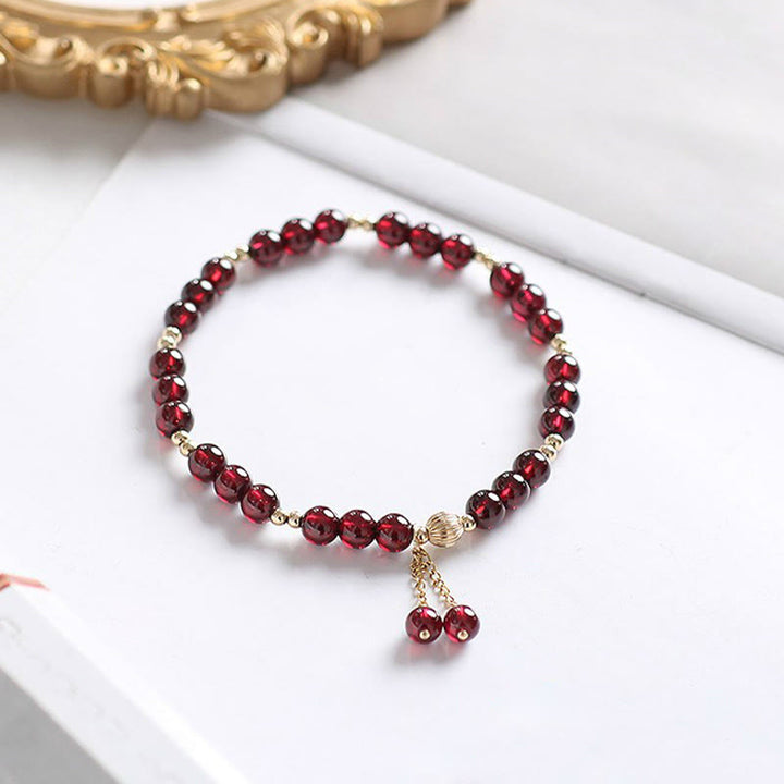 Bracciale Buddha Stones in oro 14K con granato naturale e calma