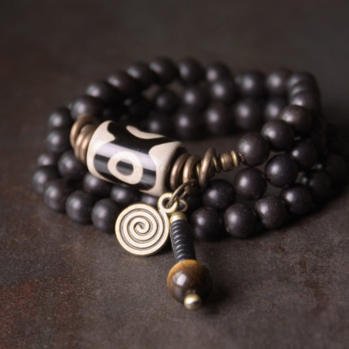 Braccialetto di coppia di protezione in rame con perline di Dzi in legno di ebano Buddha Stones