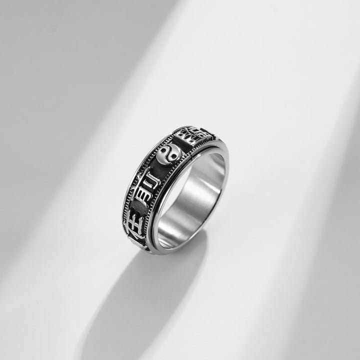 Anello girevole in acciaio al titanio con parole in equilibrio e calma