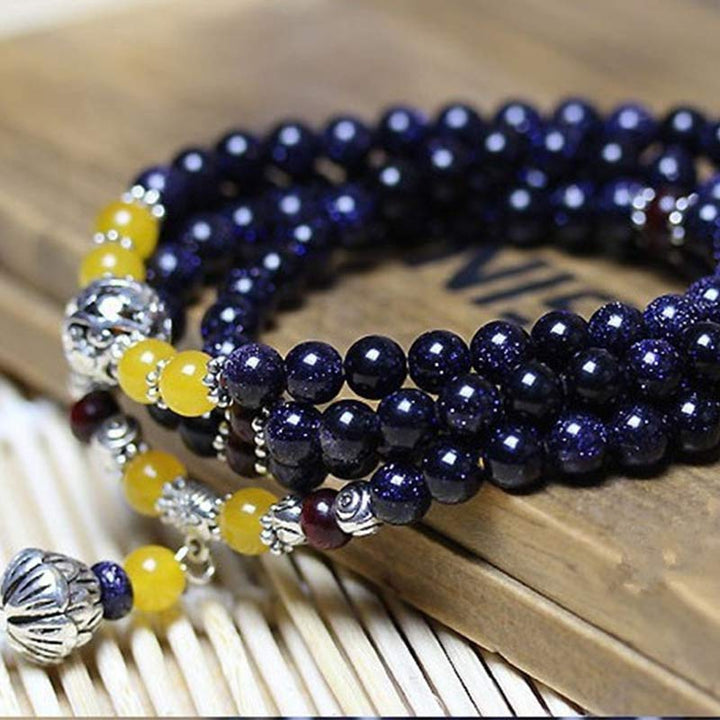 Braccialetto Mala con ciondolo di ricchezza in arenaria blu Buddha Stones