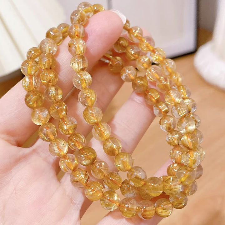 Bracciale Buddha Stones in oro naturale, quarzo rutilato, pietra del sole, cianite, ricchezza