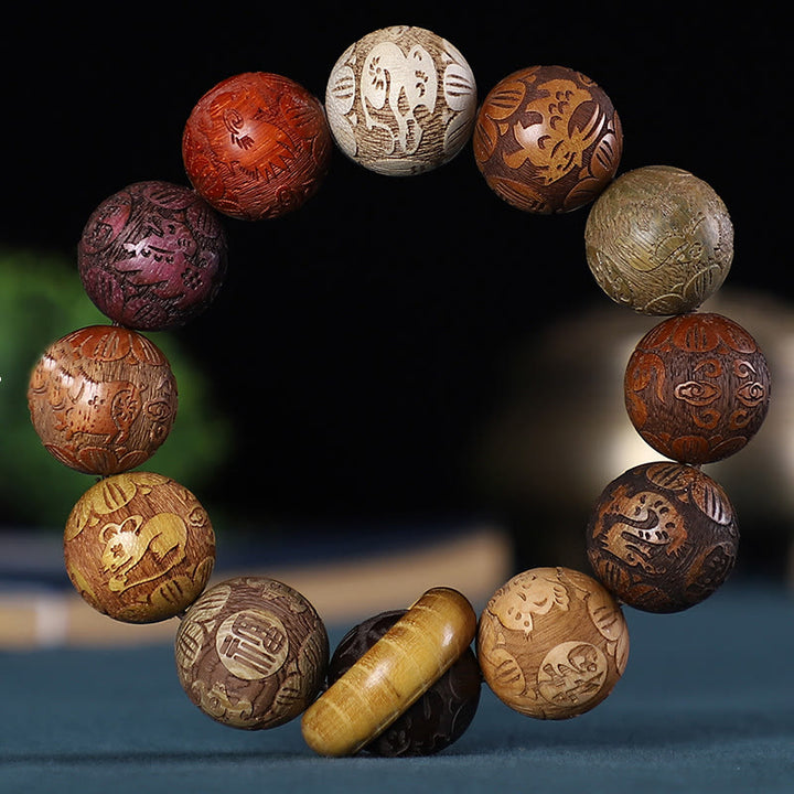 Buddha Stones Zodiaco cinese Palissandro Sandalo verde Legno di ebano Moneta di rame Braccialetto intagliato Calma