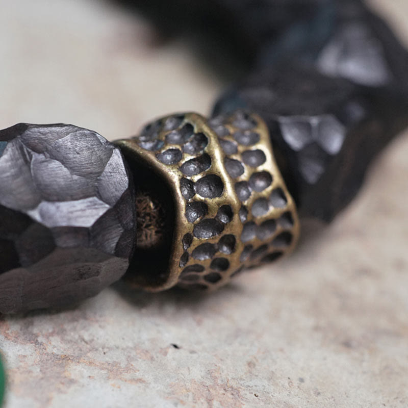 Bracciale Mala da polso con nappa in legno di Buddha Stones tibetano e rame della pace