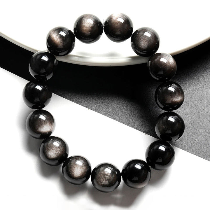Braccialetto di protezione lenitiva in ossidiana lucida d'argento naturale Buddha Stones