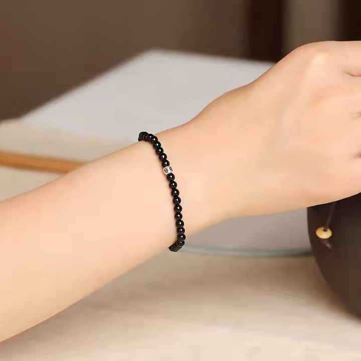 Bracciale Buddha Stones in ossidiana nera naturale e quarzo fumé per la forza di purificazione