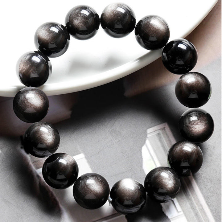 Braccialetto di protezione lenitiva in ossidiana lucida d'argento naturale Buddha Stones