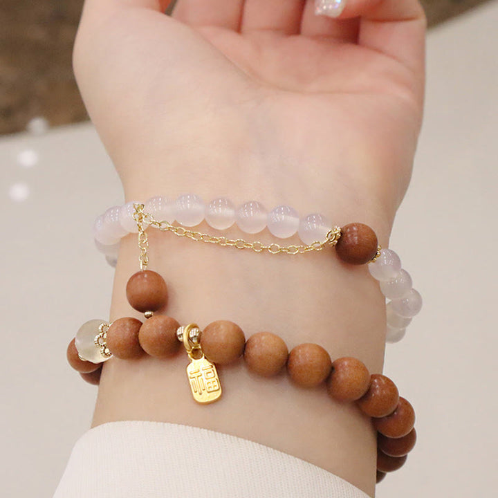 Braccialetto di protezione con ciondolo a forma di carattere Fu con occhio di gatto Buddha Stones in legno di sandalo