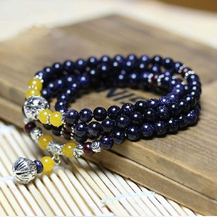 Braccialetto Mala con ciondolo di ricchezza in arenaria blu Buddha Stones