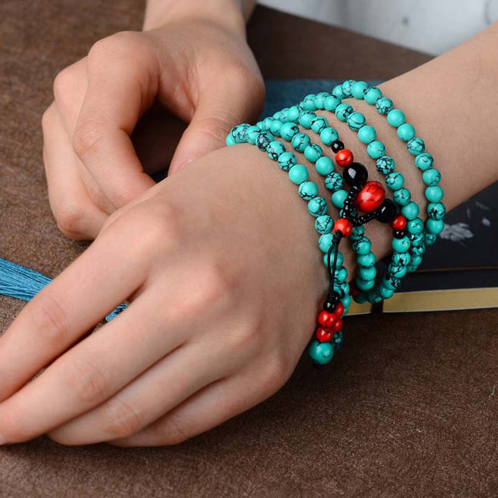 Braccialetto di protezione con perline di turchese rosso e onice nero Buddha Stones