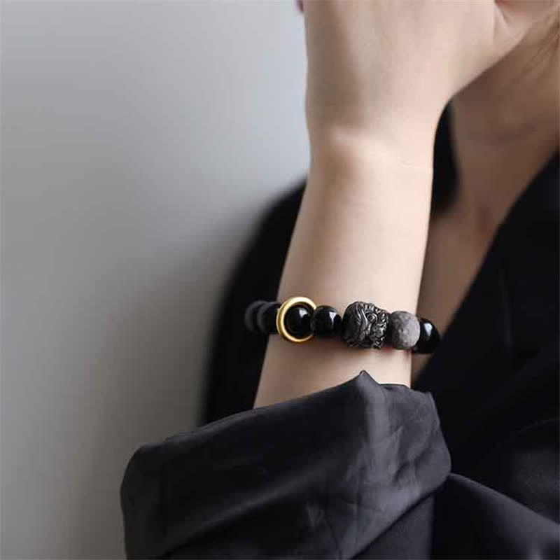 Bracciale in ossidiana nera, argento lucido e forza del leone