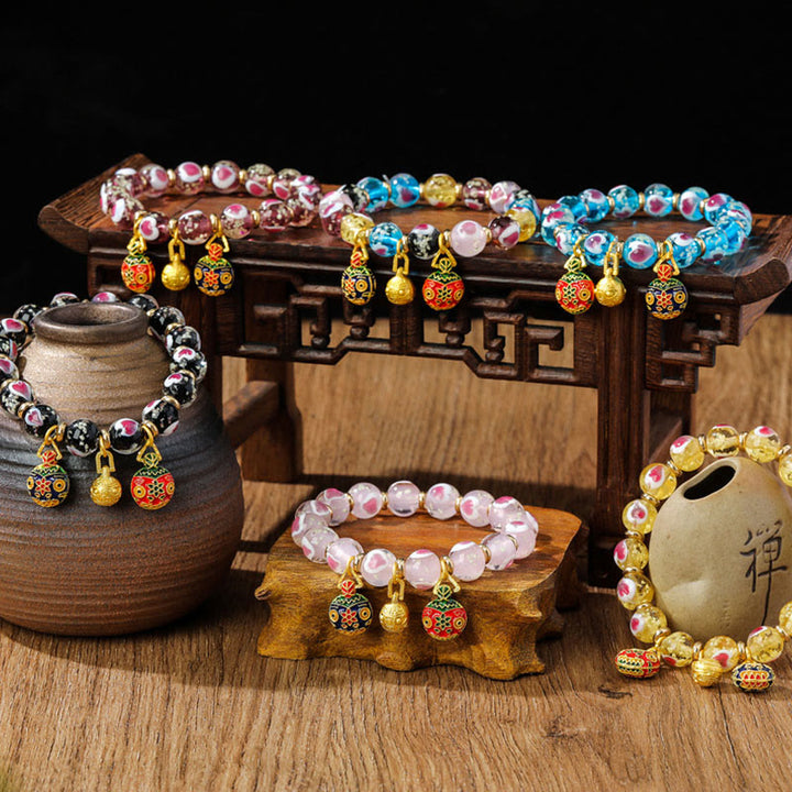 Braccialetto di perline di vetro fluorescente luminoso Liuli con cuore rosa della famiglia di bestie che ingoiano Buddha Stones