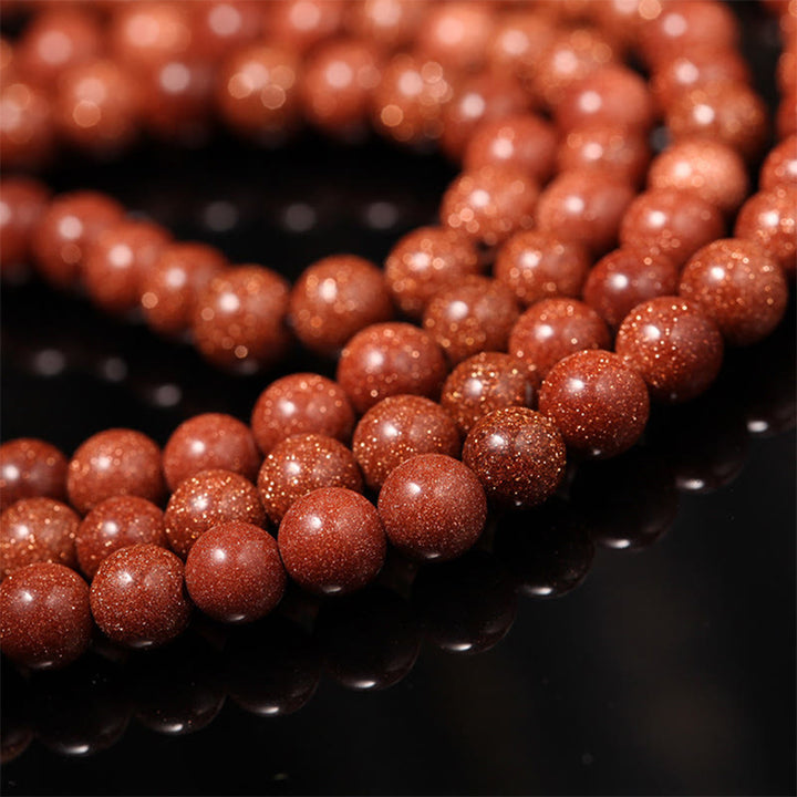 Buddha Stones 108 Mala Beads Goldstone Om Mani Padme Hum Swastika Braccialetto di Fiducia