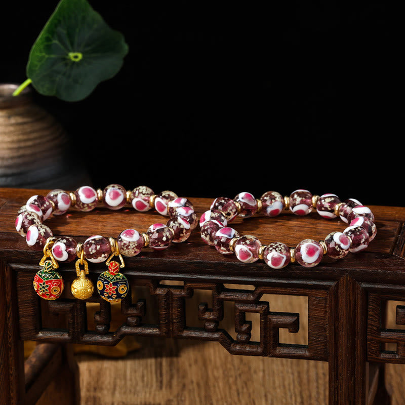 Braccialetto di perline di vetro fluorescente luminoso Liuli con cuore rosa della famiglia di bestie che ingoiano Buddha Stones