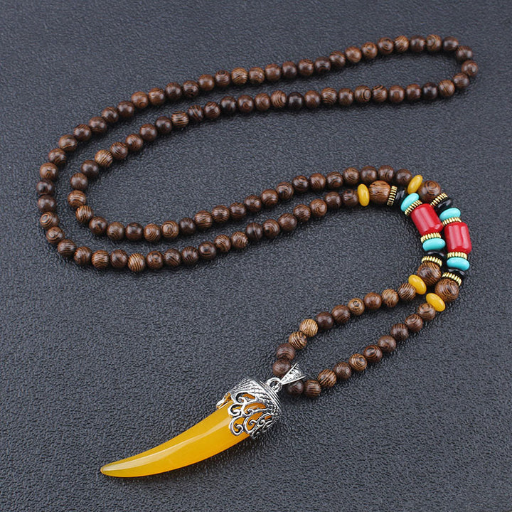 Collana con ciondolo in stile corno in pietra turchese e legno wenge, protezione e meditazione