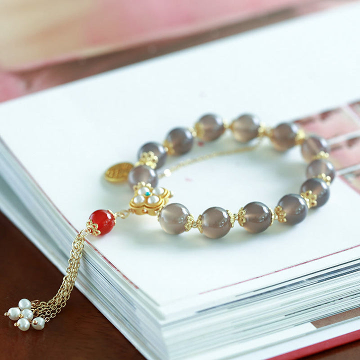 Braccialetto di equilibrio con nappa di perle di carattere Fu in agata grigia naturale Buddha Stones