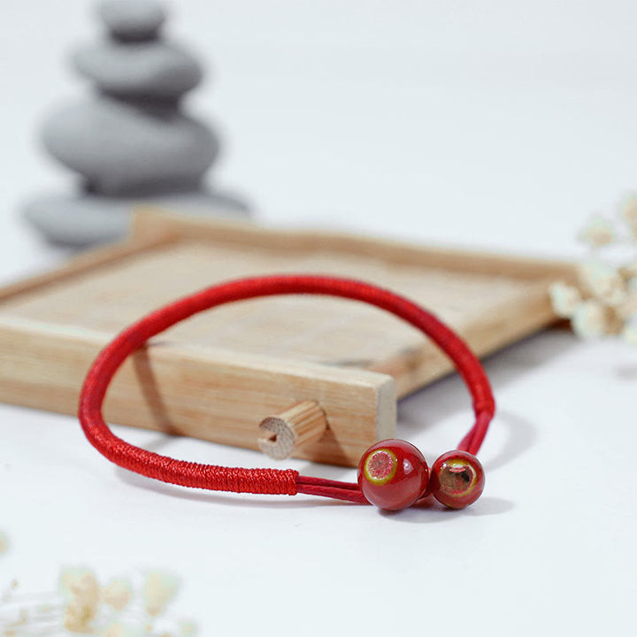 Braccialetto in ceramica con corda rossa portafortuna FengShui Buddha Stones