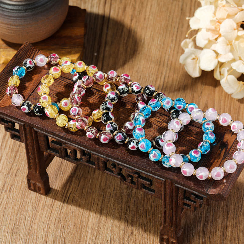 Braccialetto di perline di vetro fluorescente luminoso Liuli con cuore rosa della famiglia di bestie che ingoiano Buddha Stones