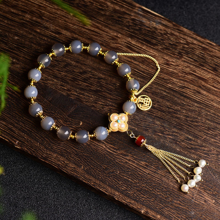 Braccialetto di equilibrio con nappa di perle di carattere Fu in agata grigia naturale Buddha Stones